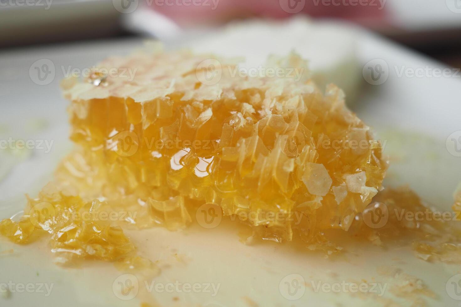 close up of fresh honey with comp in a jar photo