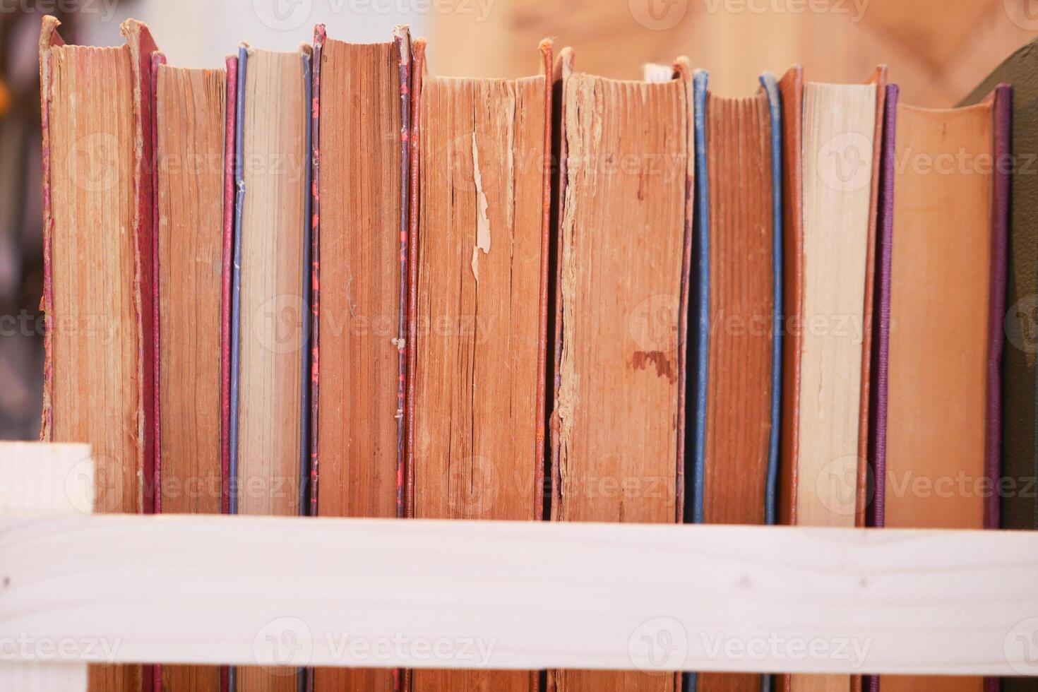 A lot of books are on the shelf in a public library or bookstore photo
