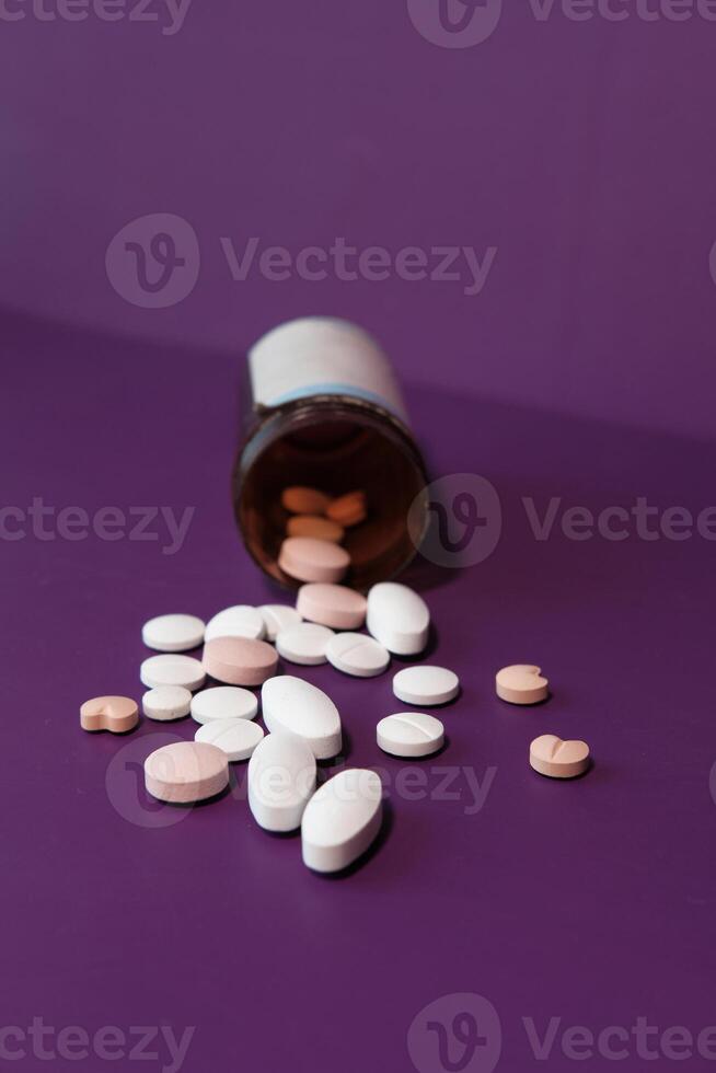 high angle view of colorful pills on color background photo