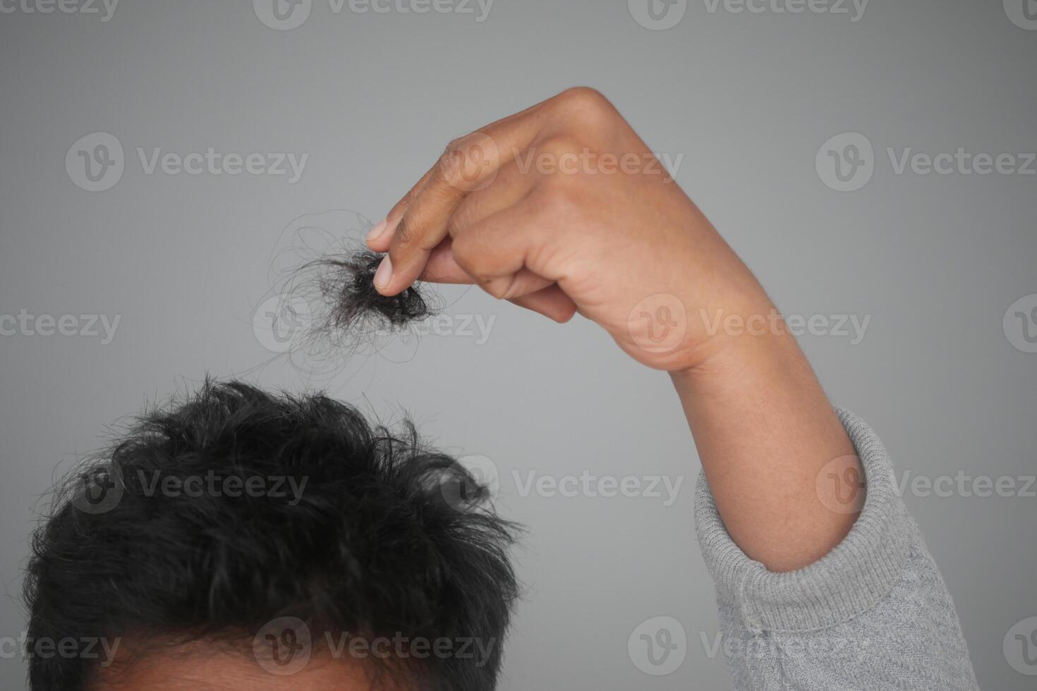 hair loss concept with man checking his hair photo