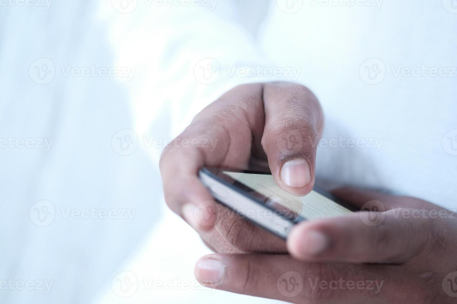 Close up of a young man using mobile smart phone photo