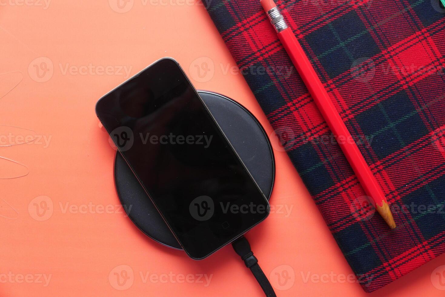 charging Smartphone Using Wireless Charging Pad, photo