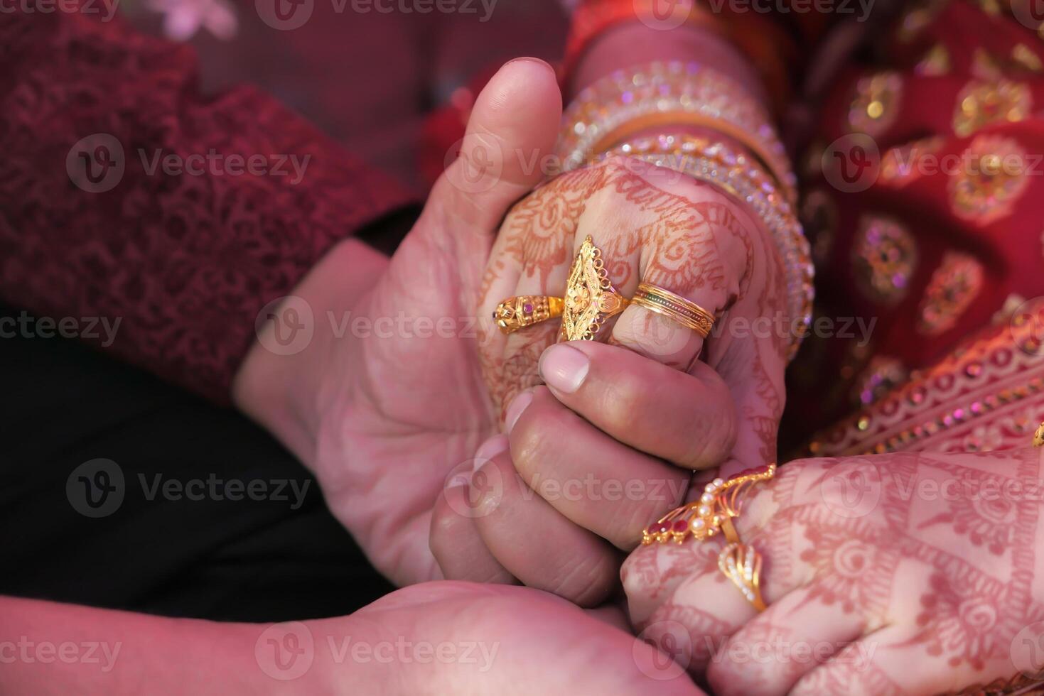 indian bride and groom holding hands at wedding day photo