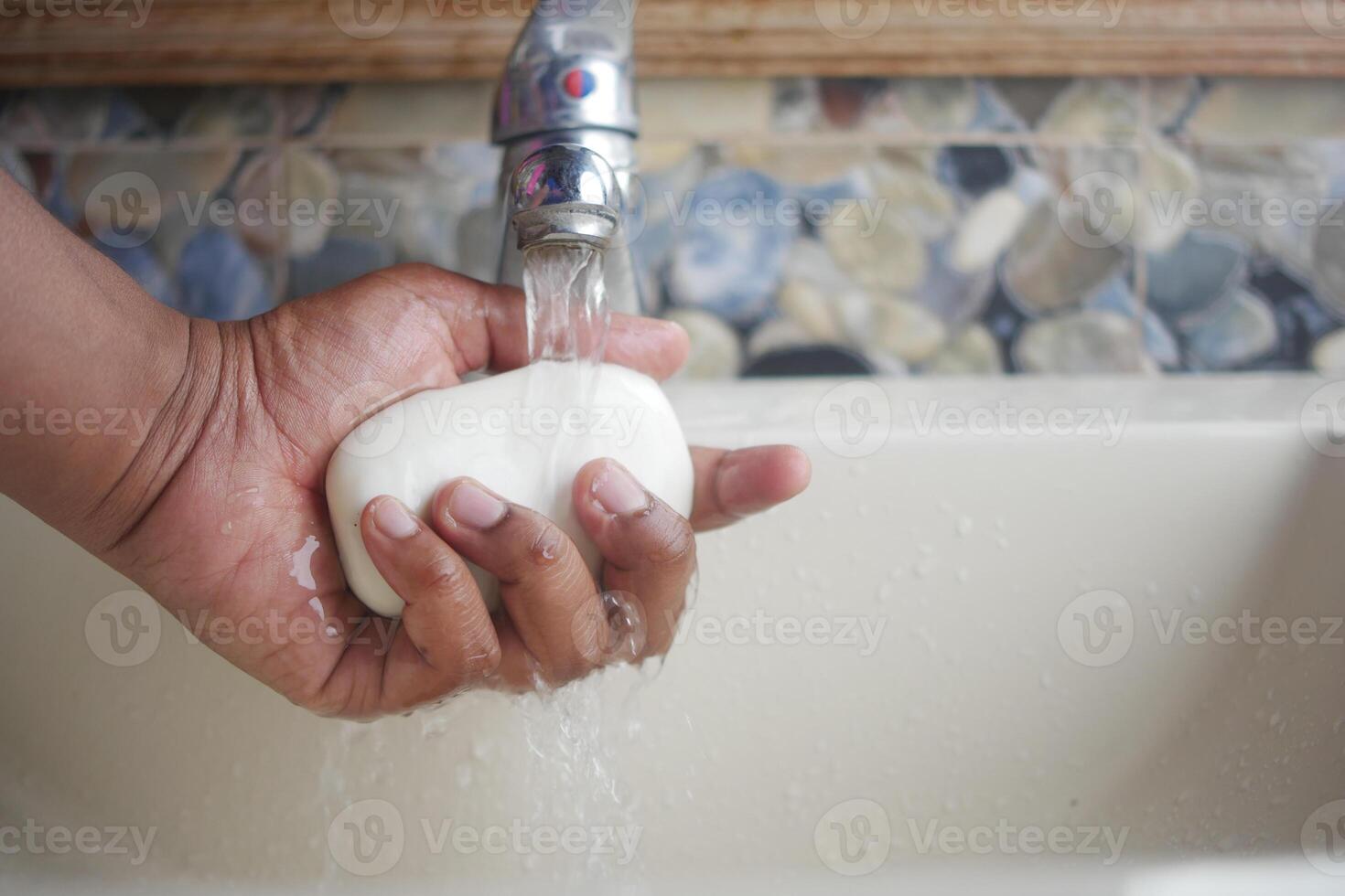 Maintaining hand cleanliness and preventing germs involves hand washing with soap and running water photo