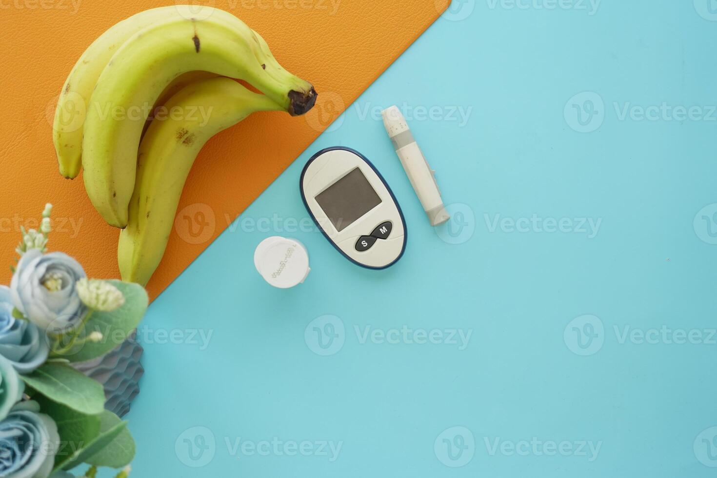 diabetic measurement tools and banana on a color background photo