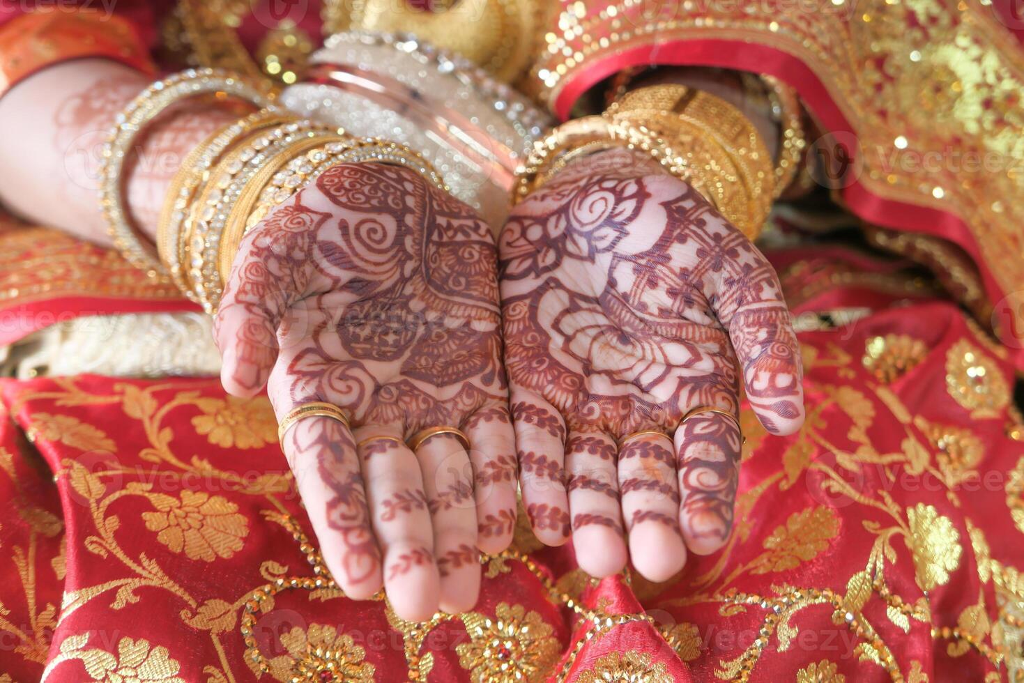 indian bride hands painted with henna close up photo