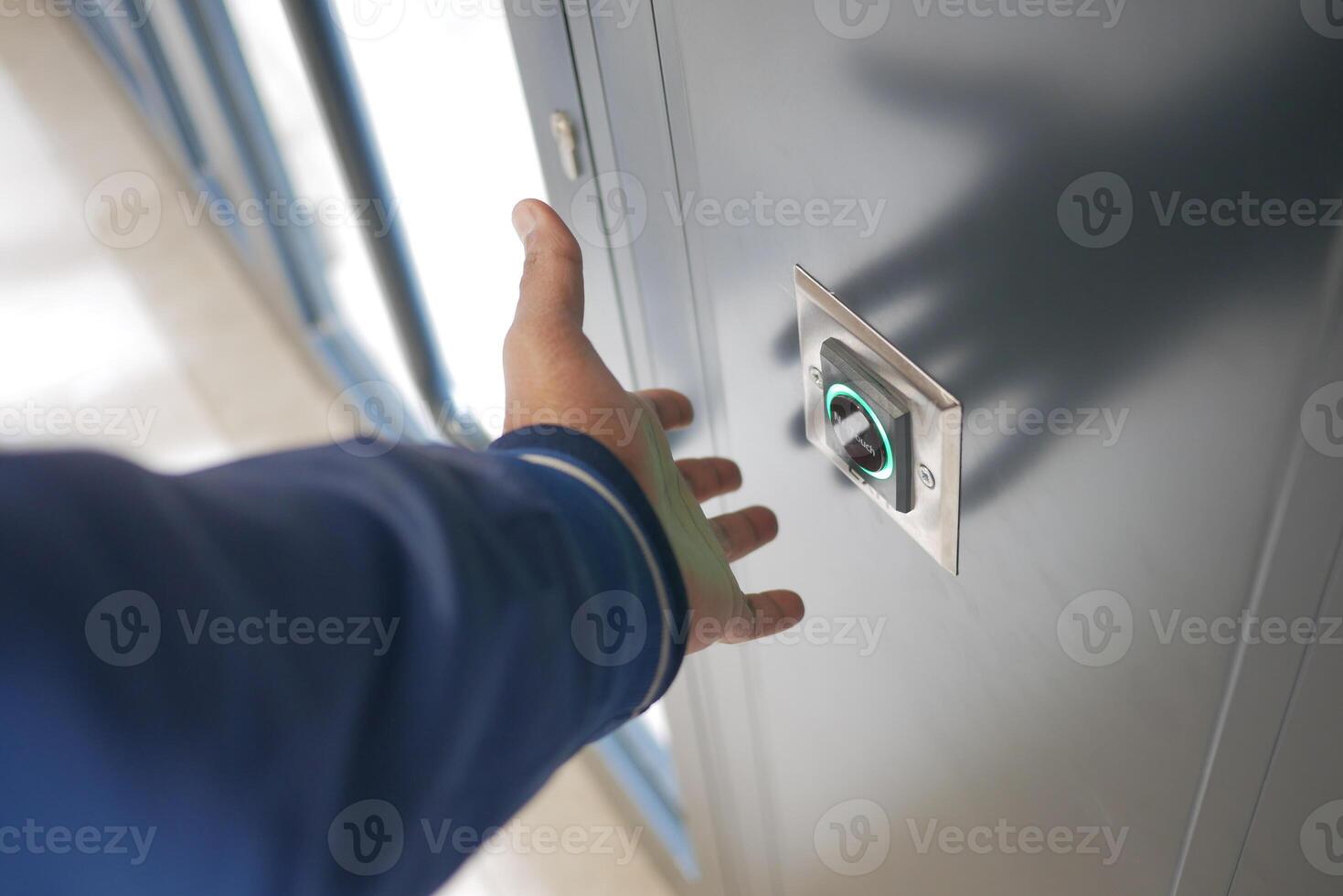 Close up of an exit button on a hardwood door in electric blue font photo