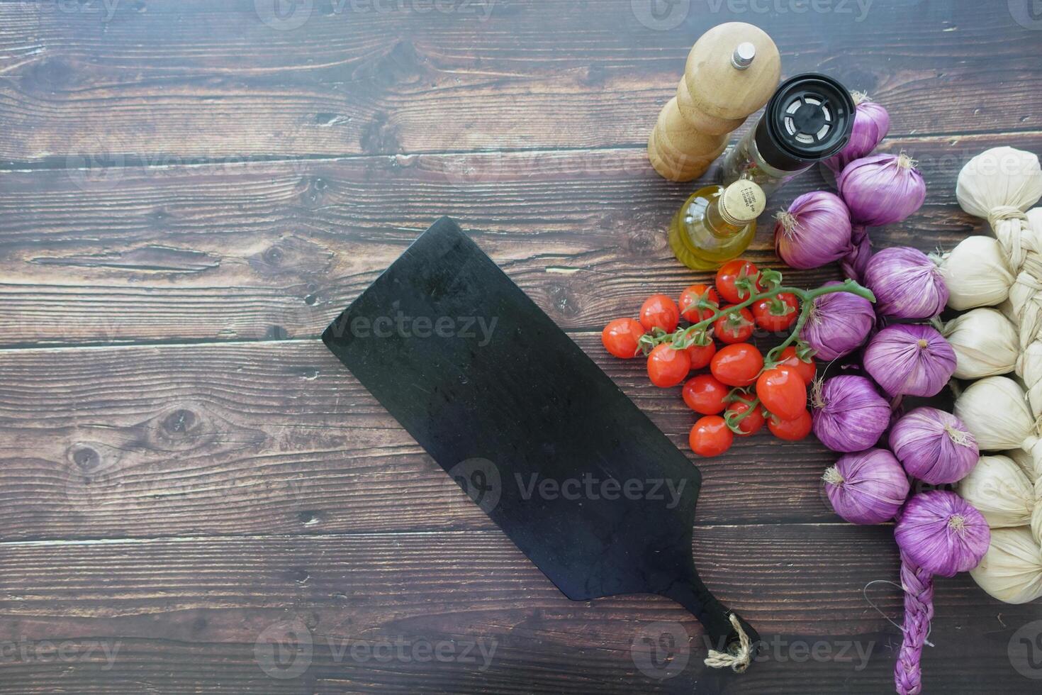 Healthy food selection with fresh vegetables and a chopping board on table photo