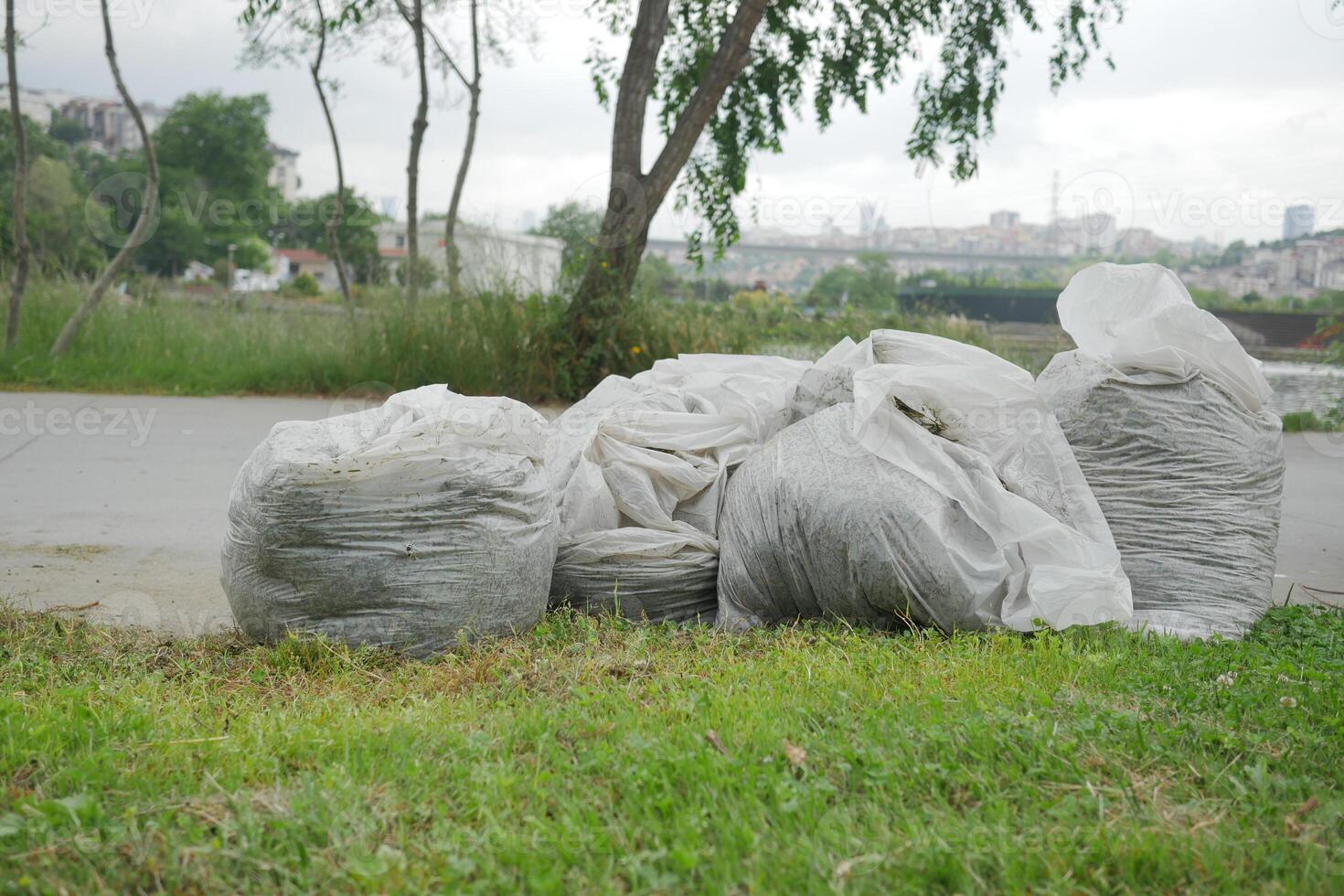garbage bags stack on a park photo