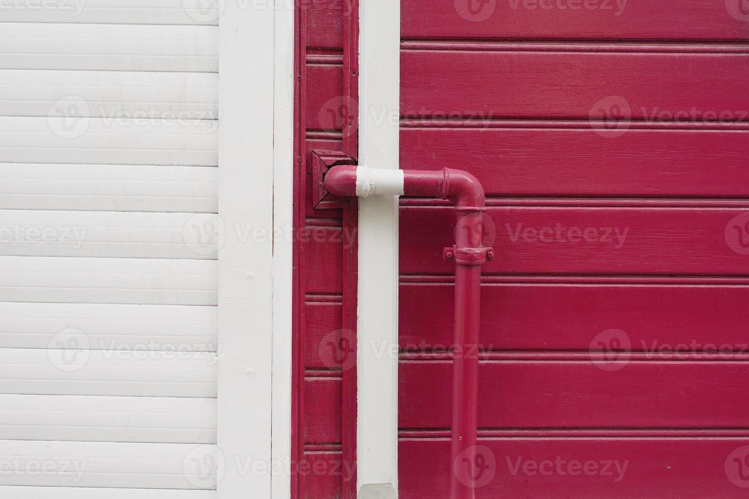 red wall with pipe, displaying modern urban design with vibrant colors photo