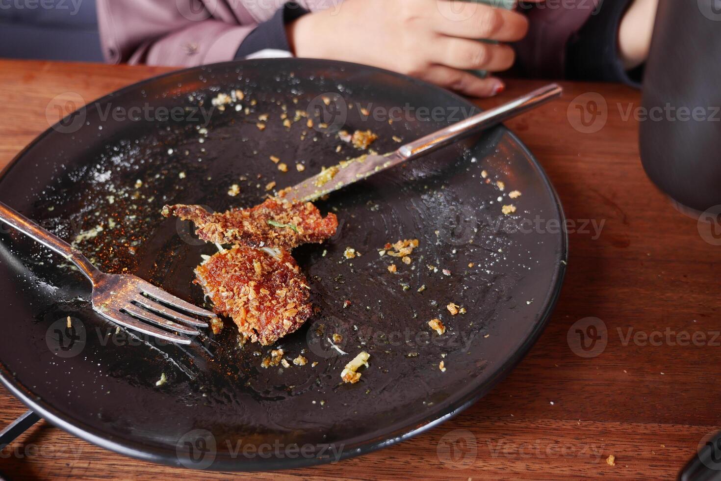 An empty dirty plate with a fork. photo