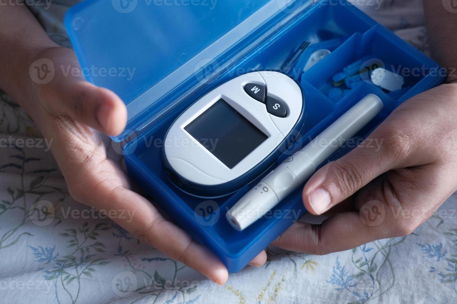 young women test blood sugar for diabetes, close up photo