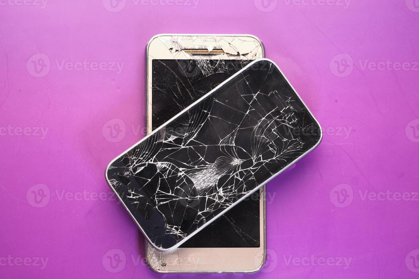Close up of broken smart phone on color background photo