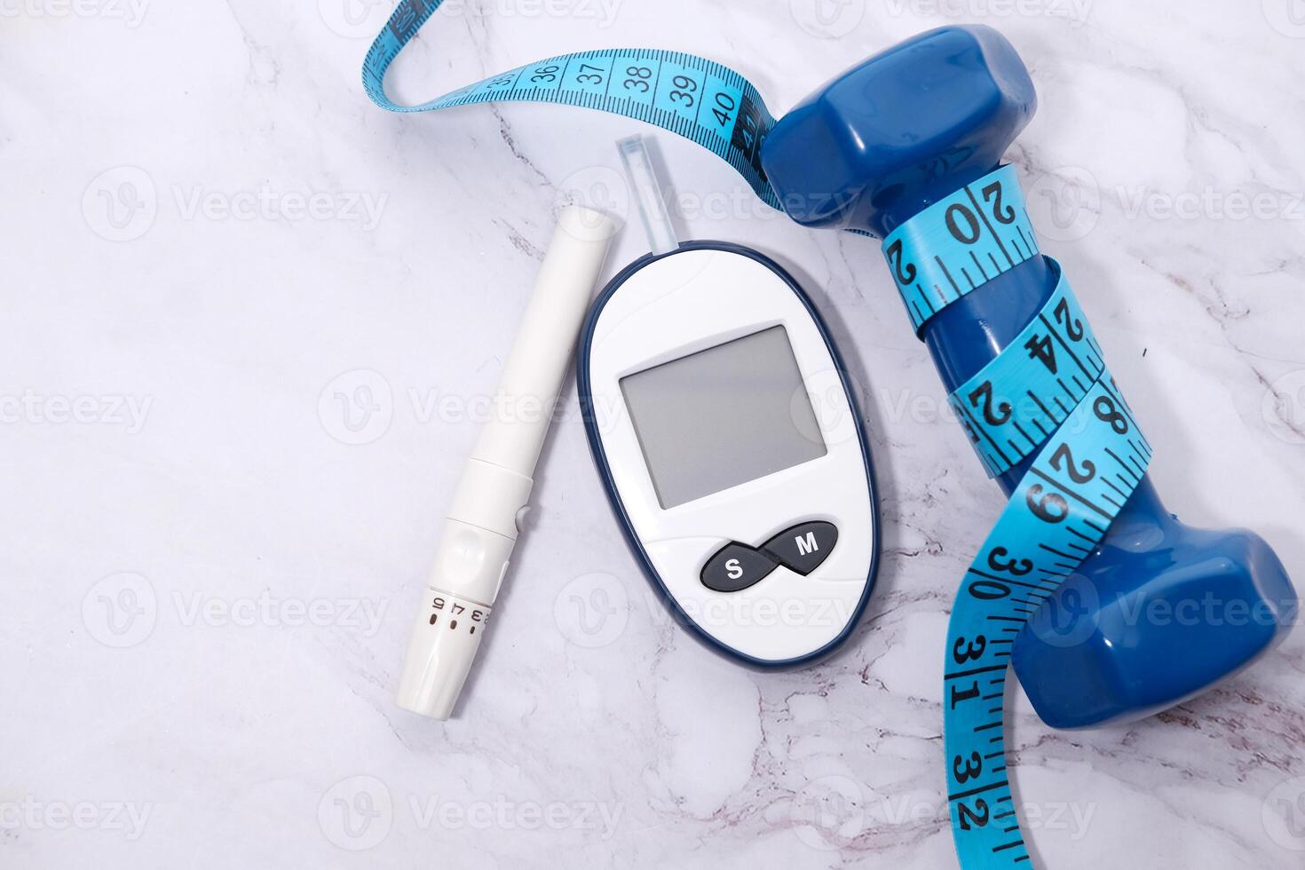 Top view glucose meter machine and dumbbell on white photo