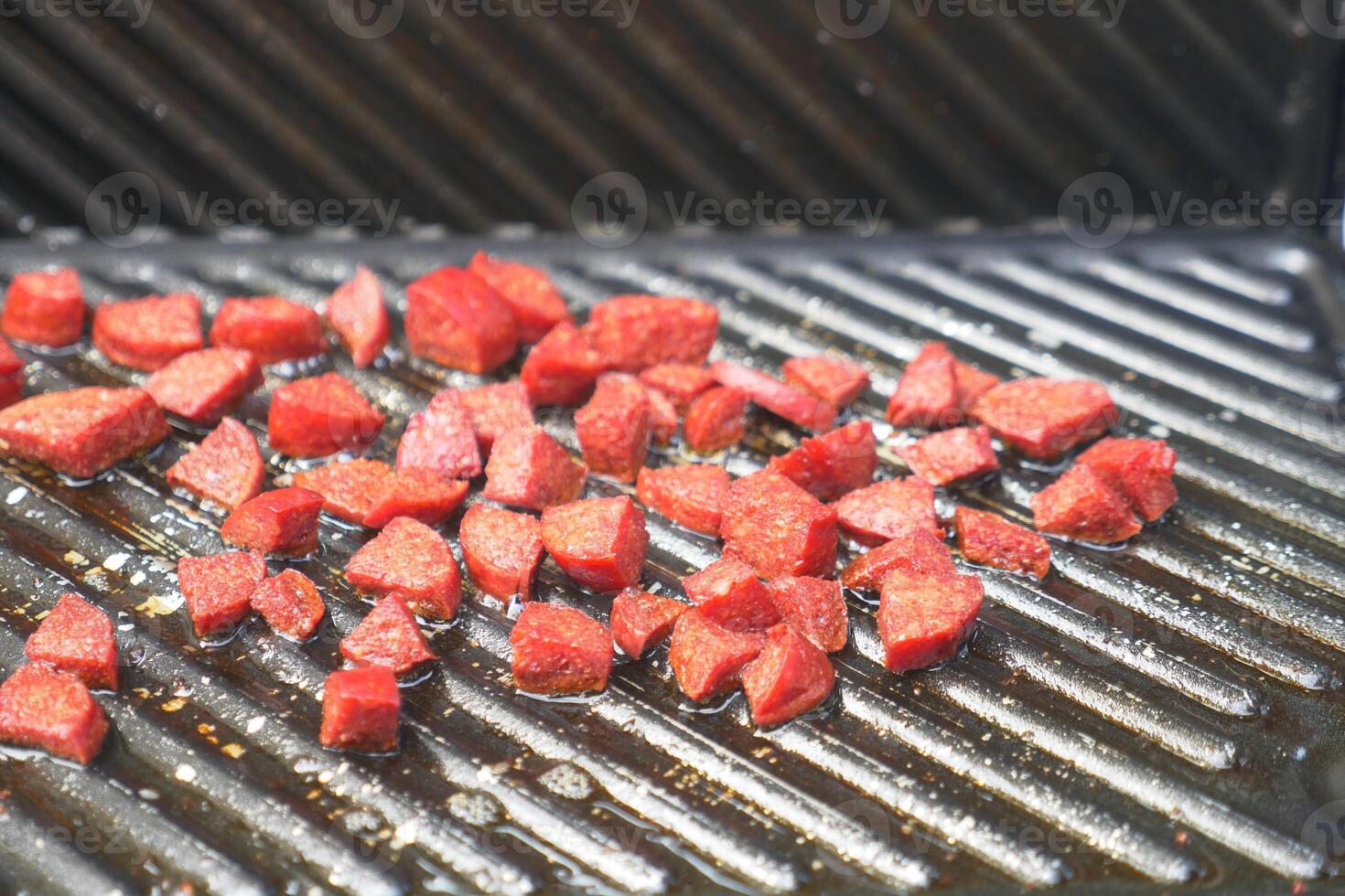 slice of salami sausage on the grill photo