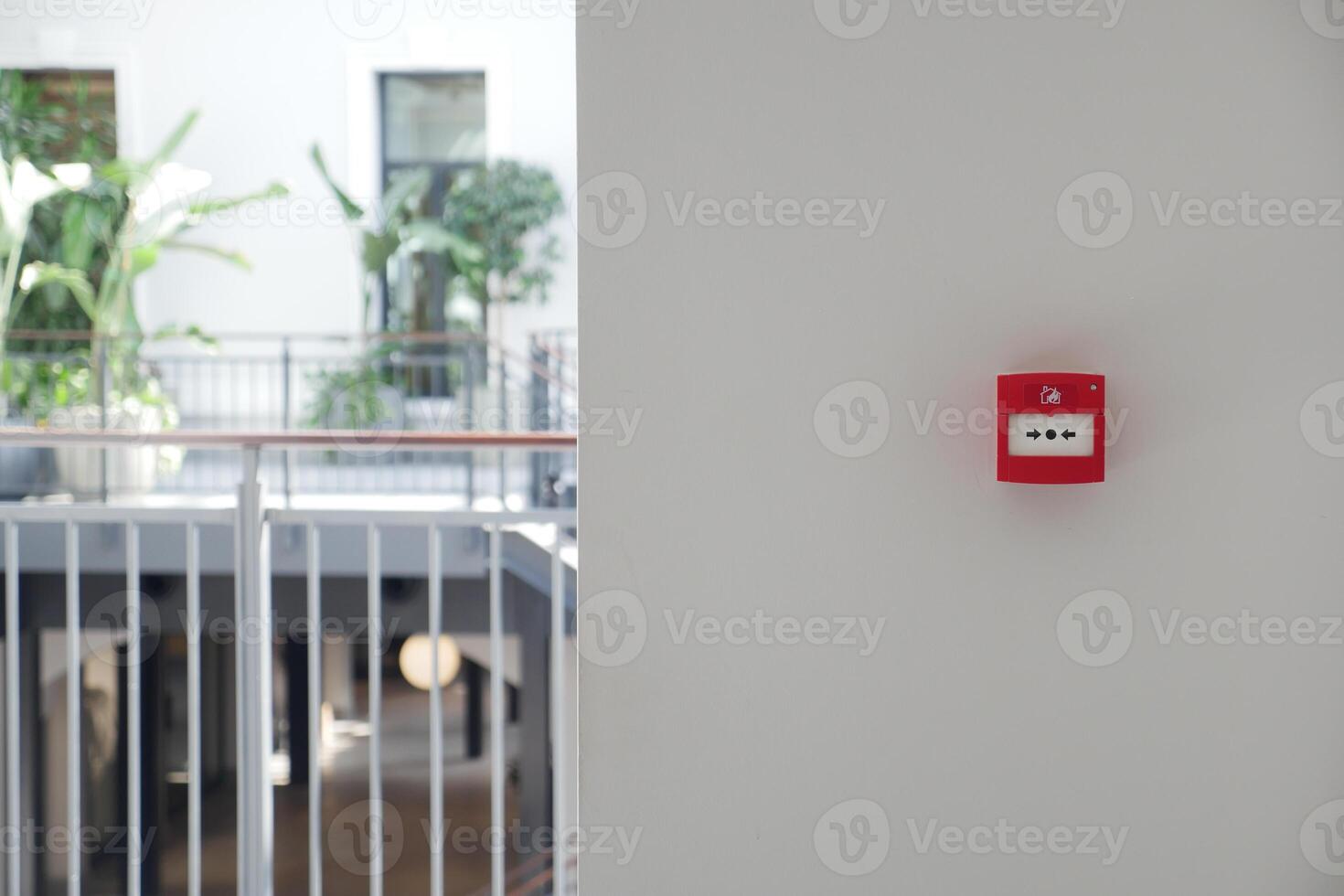 Red fire alarm button on wall , photo