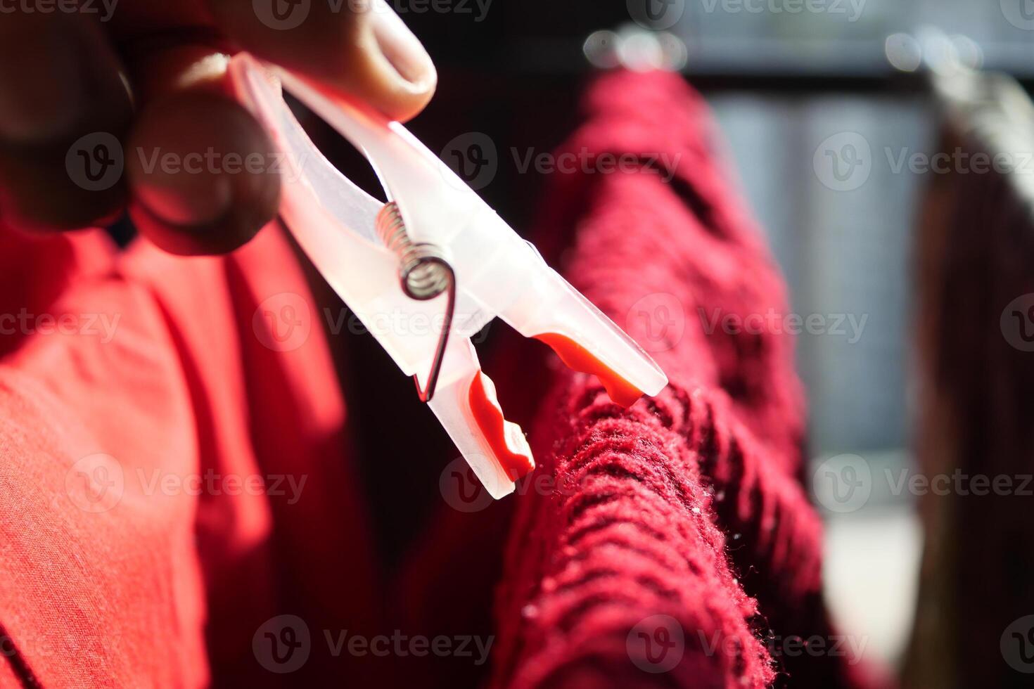 putting a blue clothespins on cloth photo