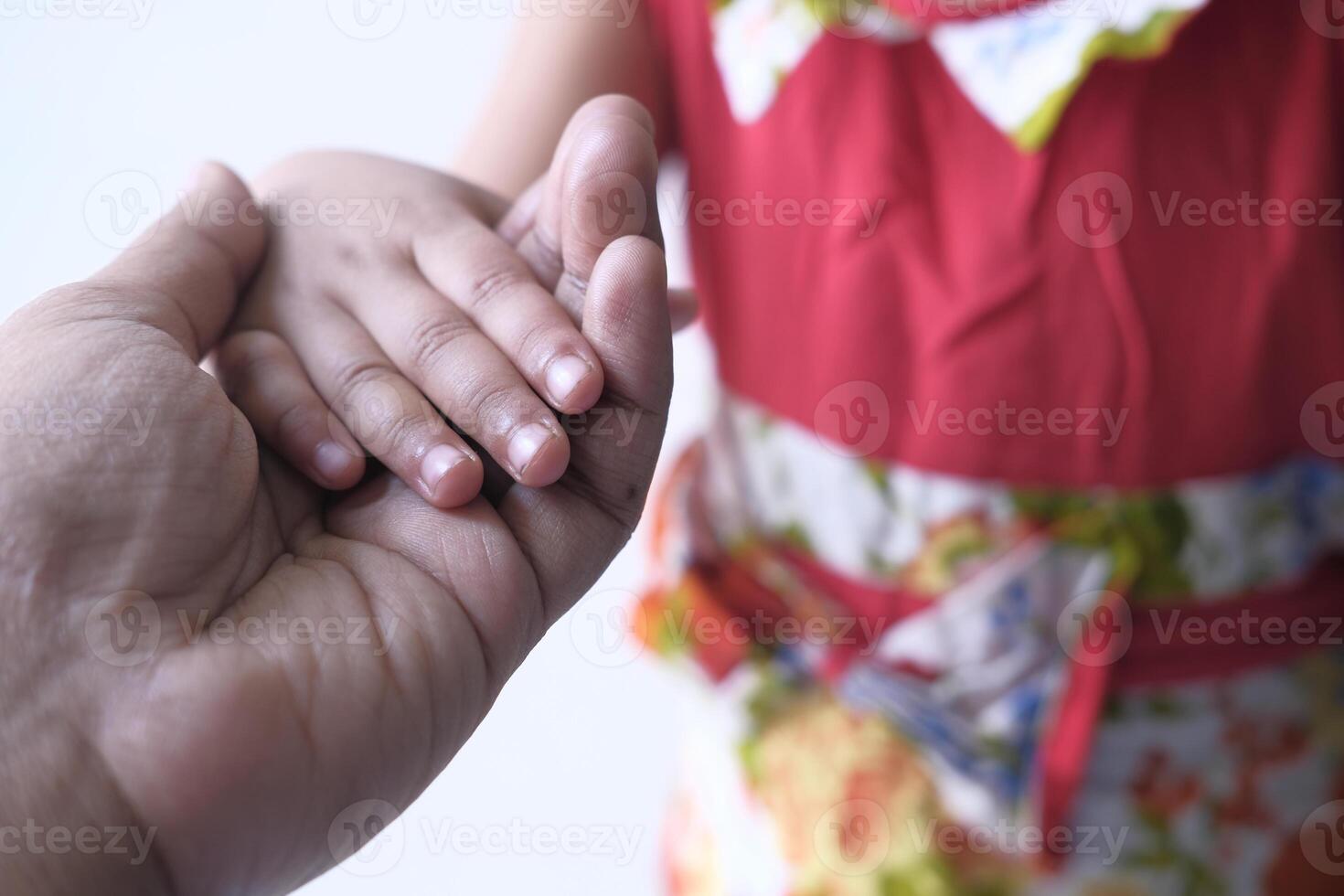 father holding hand of his child, close up photo
