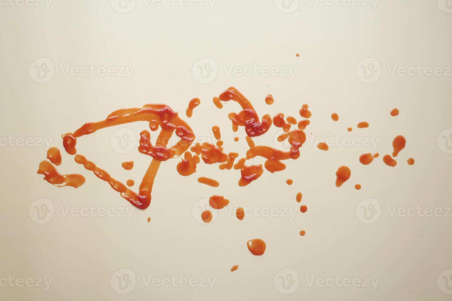 red ketchup splashes on purple background, tomato puree texture. photo