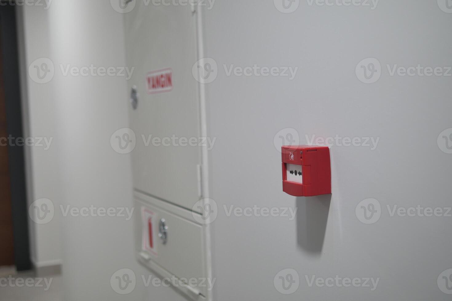 Red fire alarm button on wall , photo