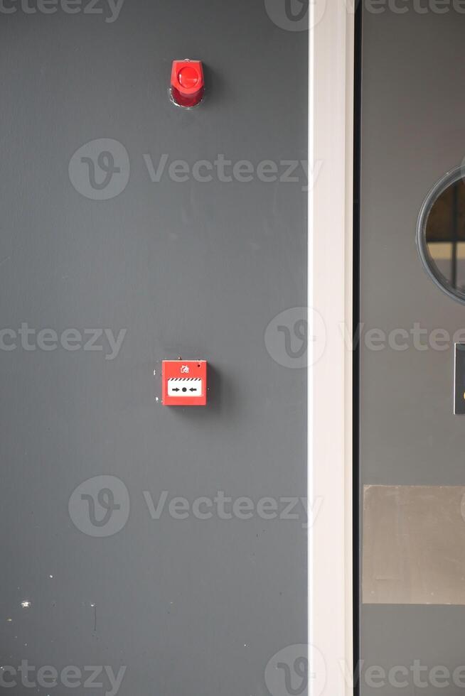 Red fire alarm button on wall , photo