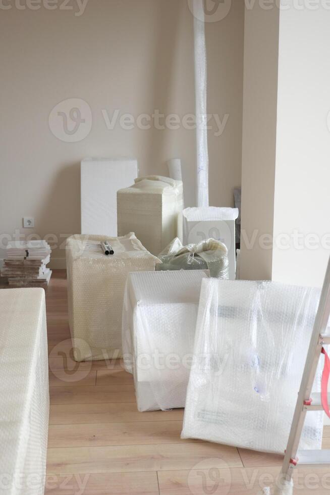 An empty room with hardwood flooring and wrapped in plastic. photo