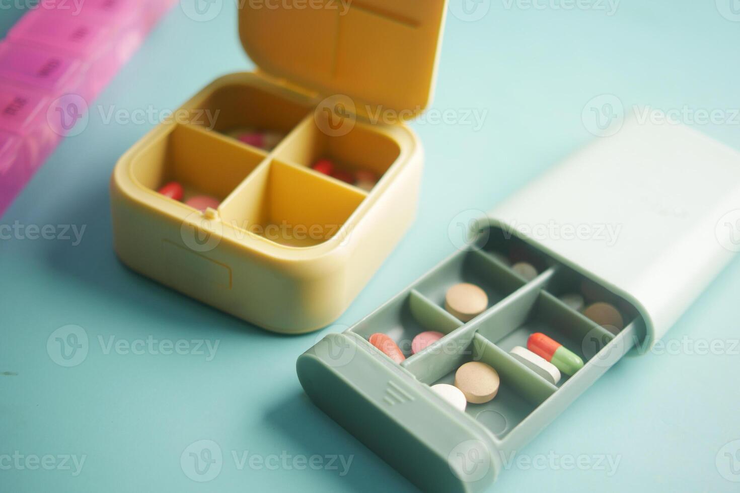 close up of medical pills in a pill box on table photo
