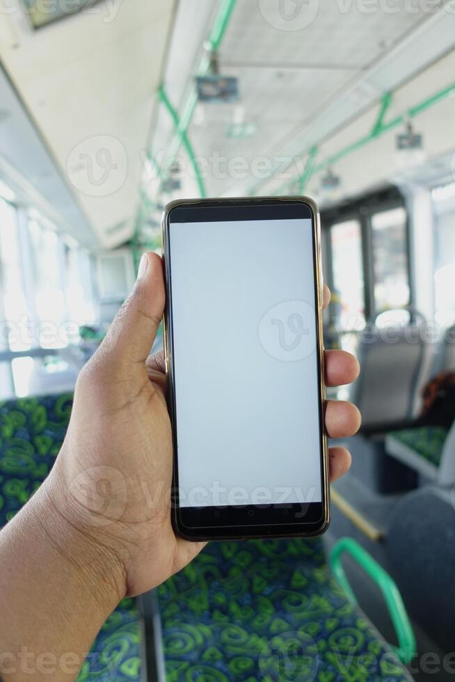 passenger sitting in a bus using his phone. photo