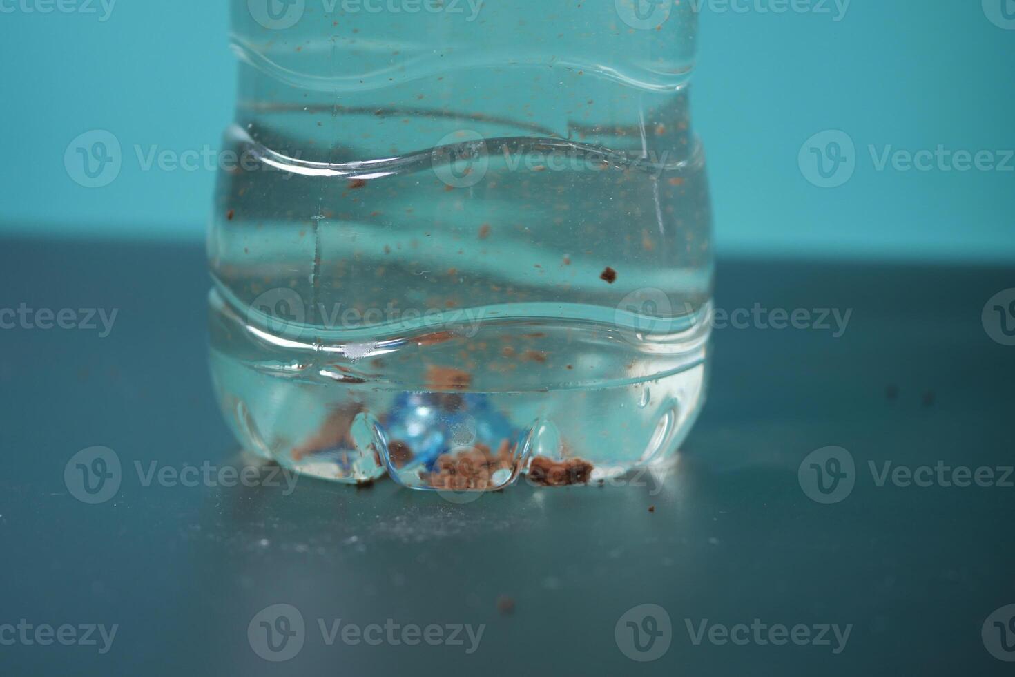 dirty bottle of water on a table photo