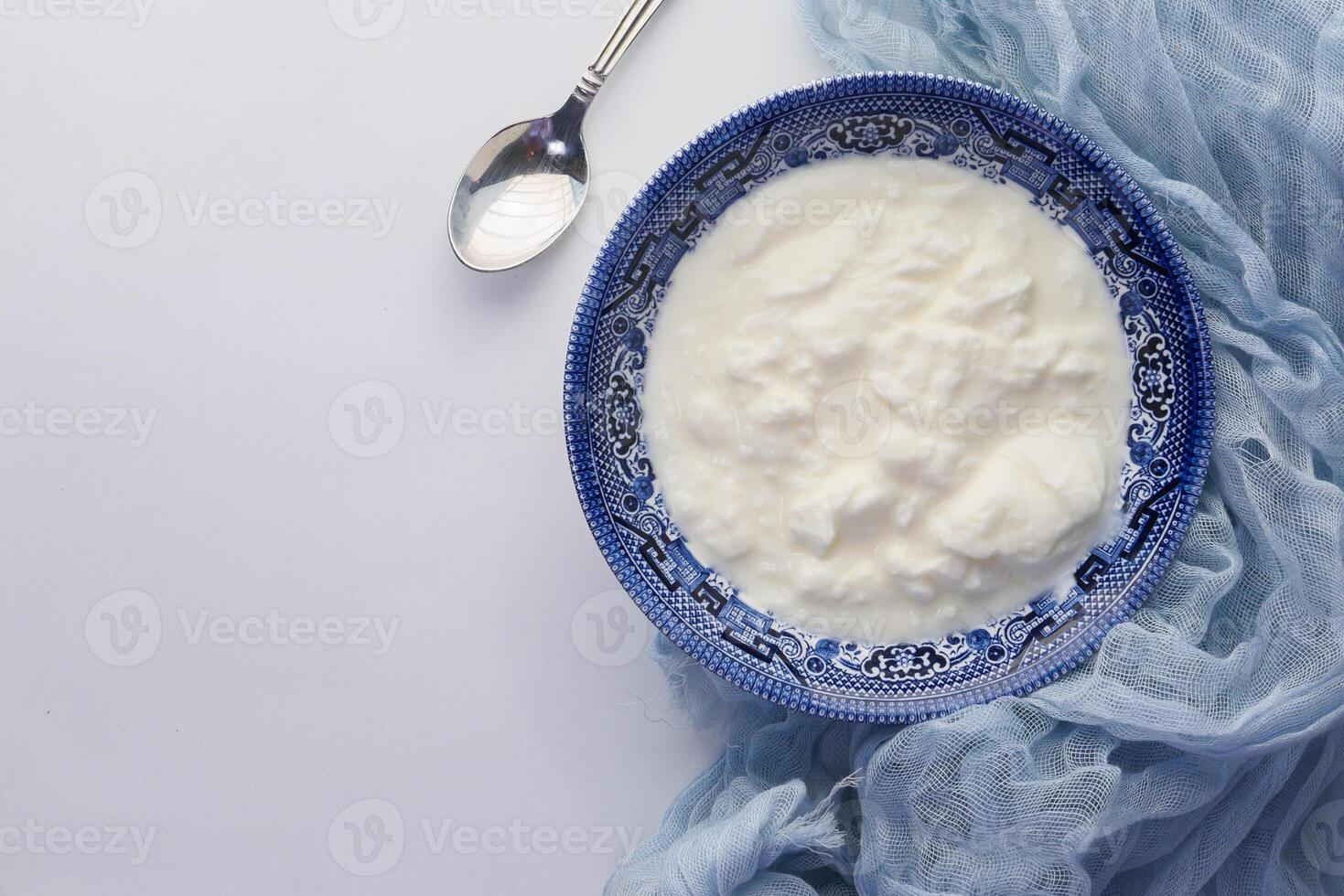 Close up of greek yogurt in a bowl on table photo