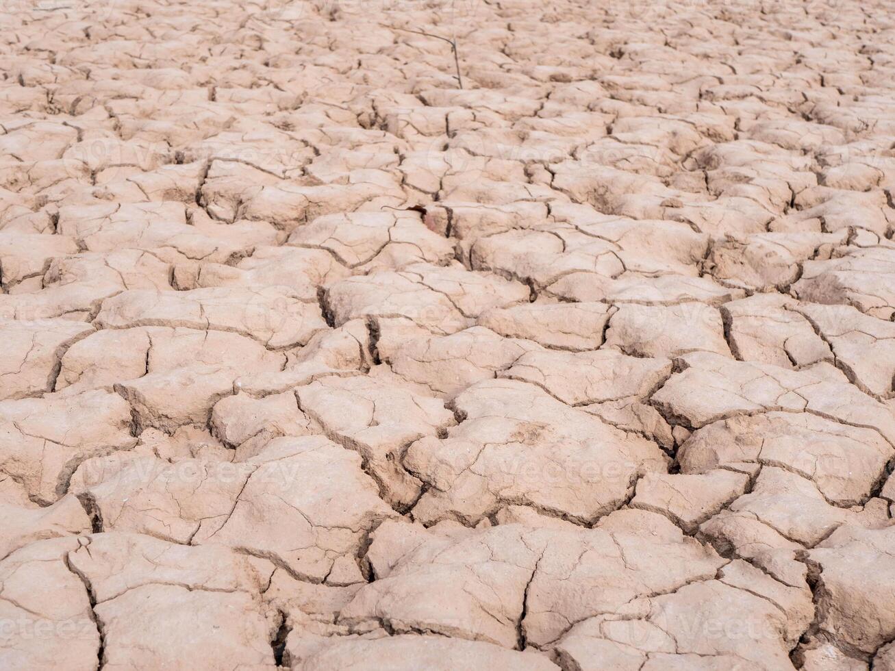 deep cracks at the bottom of a dry water reservoir, global warming concept photo