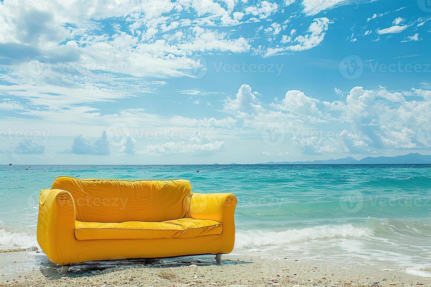 bright yellow couch is sitting on the beach next to the ocean photo