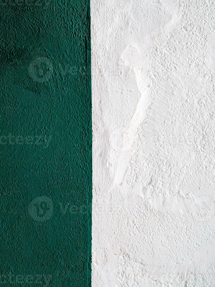 vertical white and green surface of a plastered wall, abstract concrete background photo