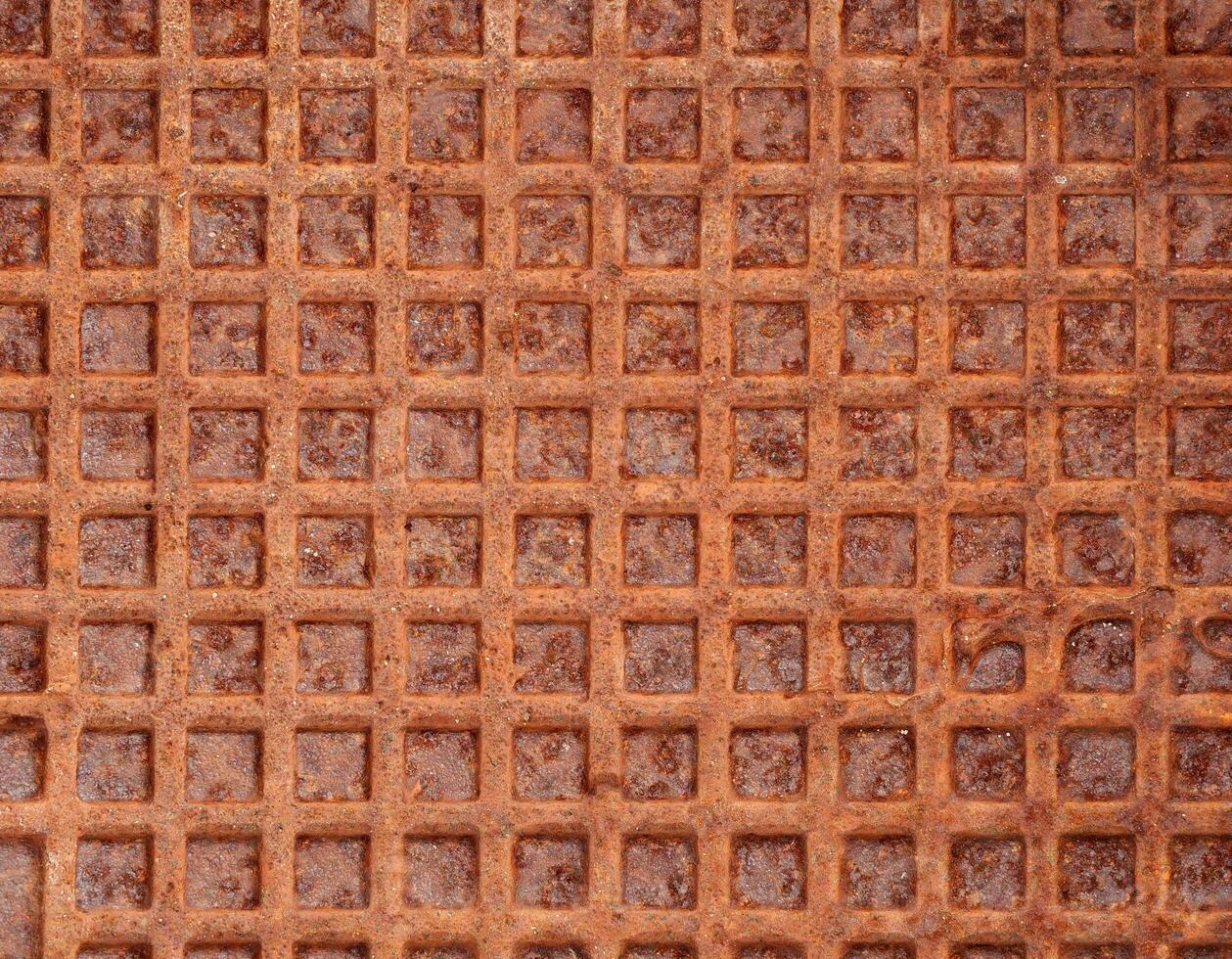 old rusty metal surface with square pattern, grunge abstract background photo