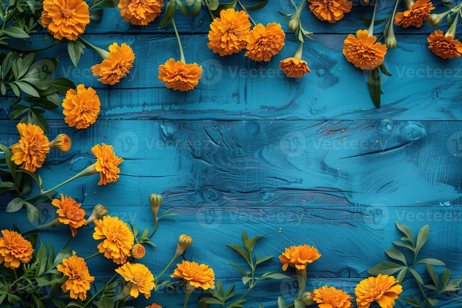 orange marigolds flowers border frame on blue painted wooden background top view, beautiful floral template with copy space photo