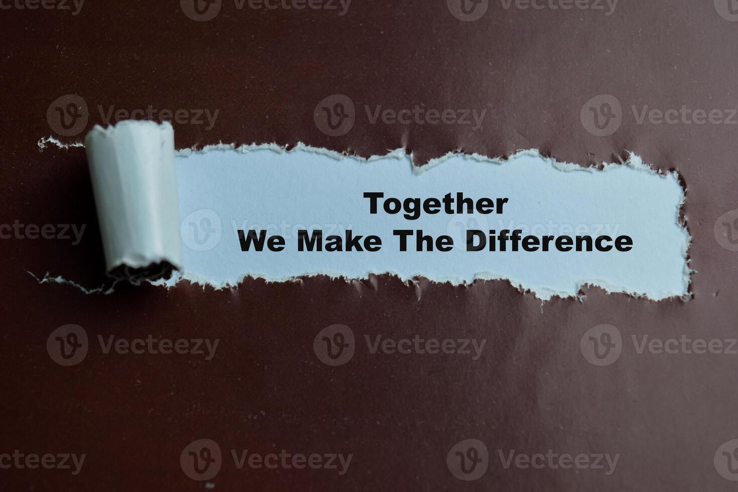 Concept of Together We Make The Difference Text written in torn paper. photo