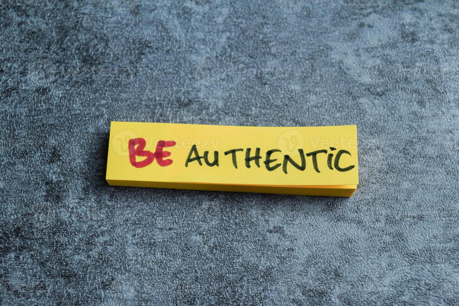 Concept of Be Authentic write on sticky notes isolated on Wooden Table. photo