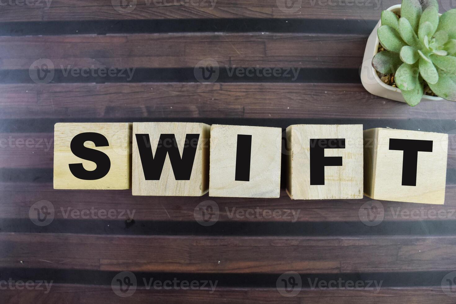 Concept of The wooden Cubes with the word Swift on wooden background. photo
