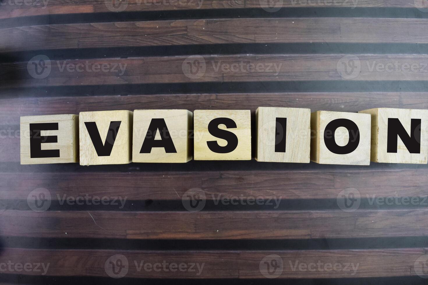 Concept of The wooden Cubes with the word Evasion on wooden background. photo