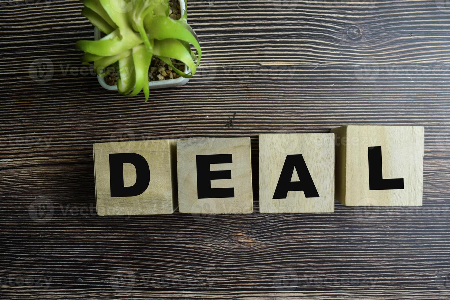 Concept of The wooden Cubes with the word Deal on wooden background. photo