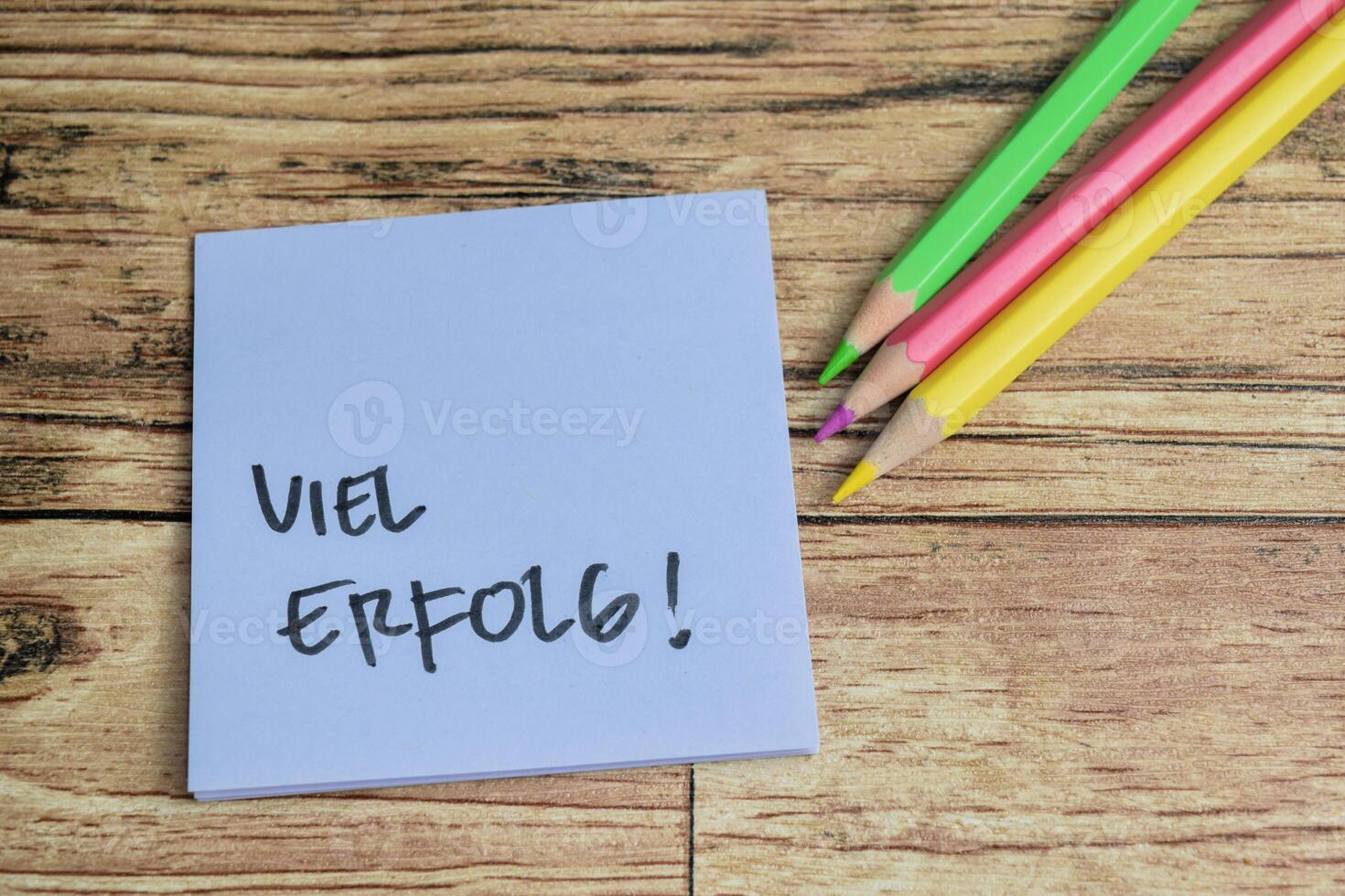Concept of Learning language - German. Viel Erfolg it means Good luck written on sticky notes. German language isolated on Wooden Table. photo