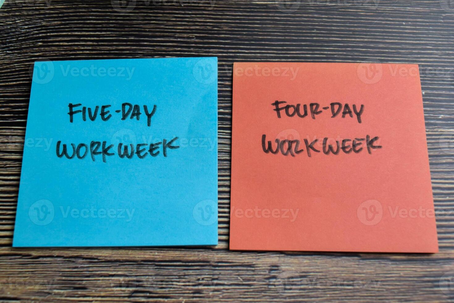 Concept of Five-day Workweek or Four-day Workweek write on sticky notes isolated on Wooden Table. photo