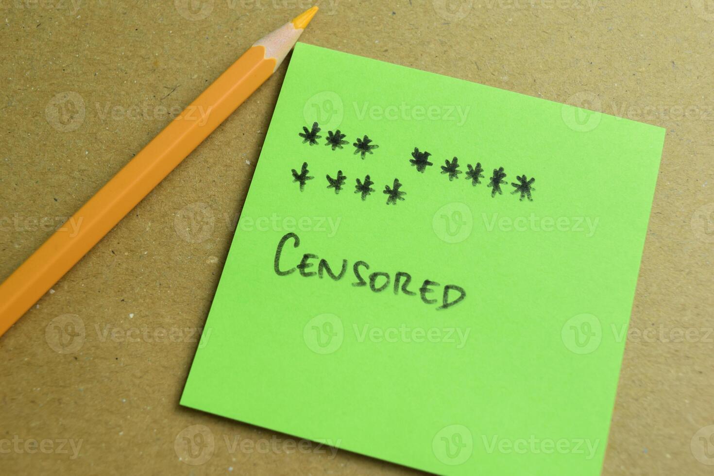 Concept of Censored write on sticky notes isolated on Wooden Table. photo