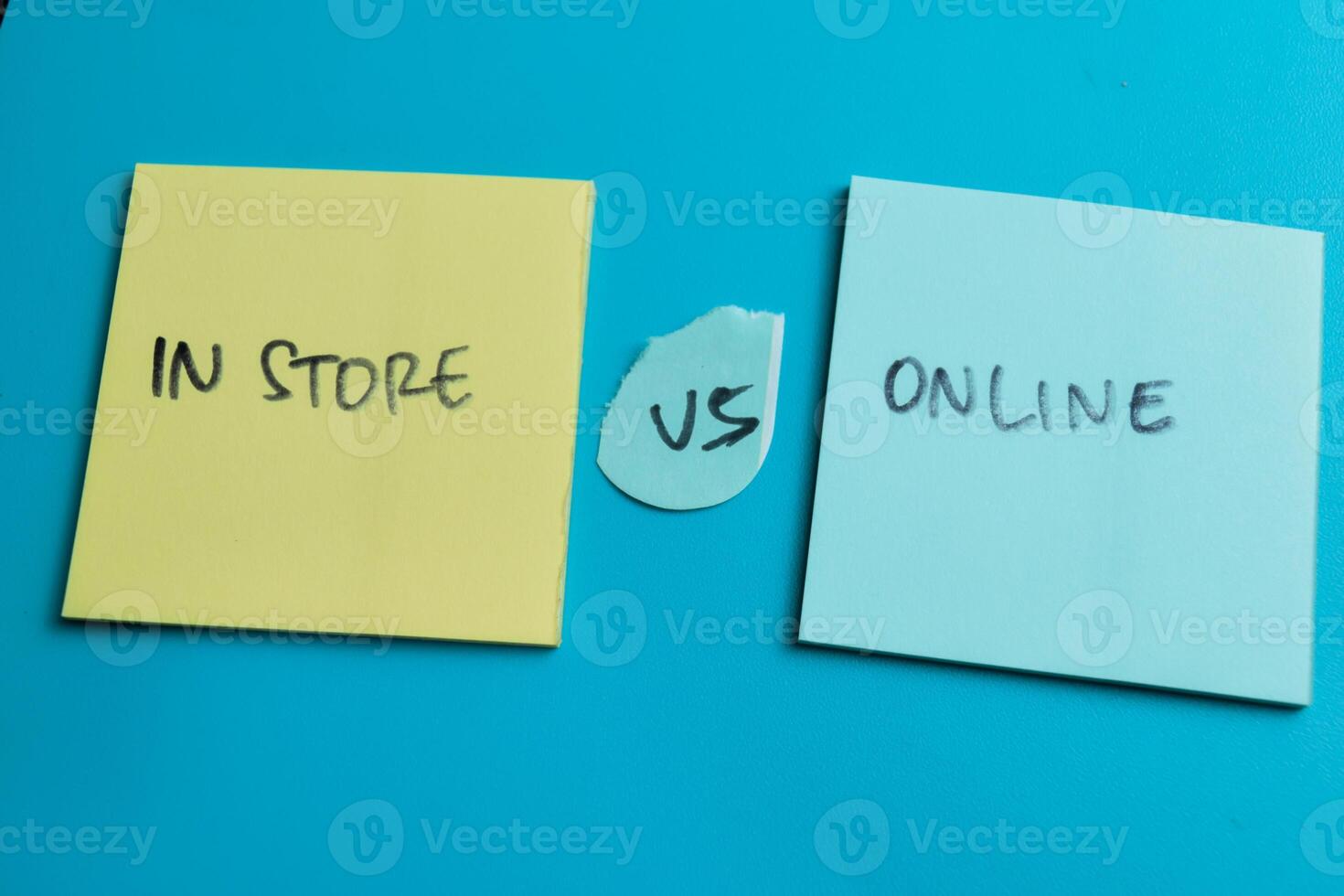 Concept of In Store vs Online write on sticky notes isolated on Wooden Table. photo