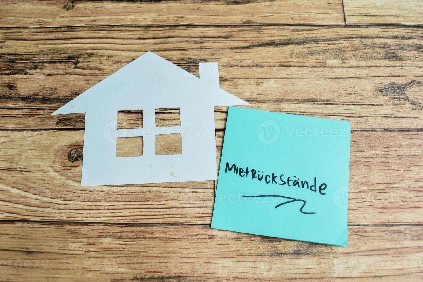 Concept of Learning language - German. Mietruck stande it means rental pressure written on sticky notes. German language isolated on Wooden Table. photo