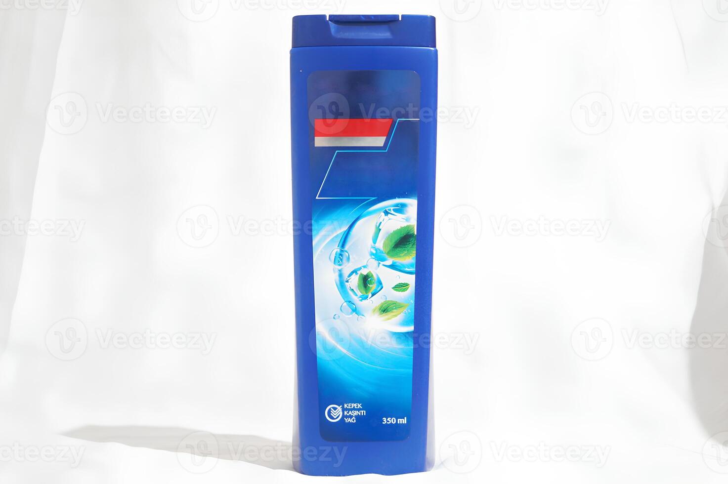 A blue bottle of shampoo with a blue cap photo