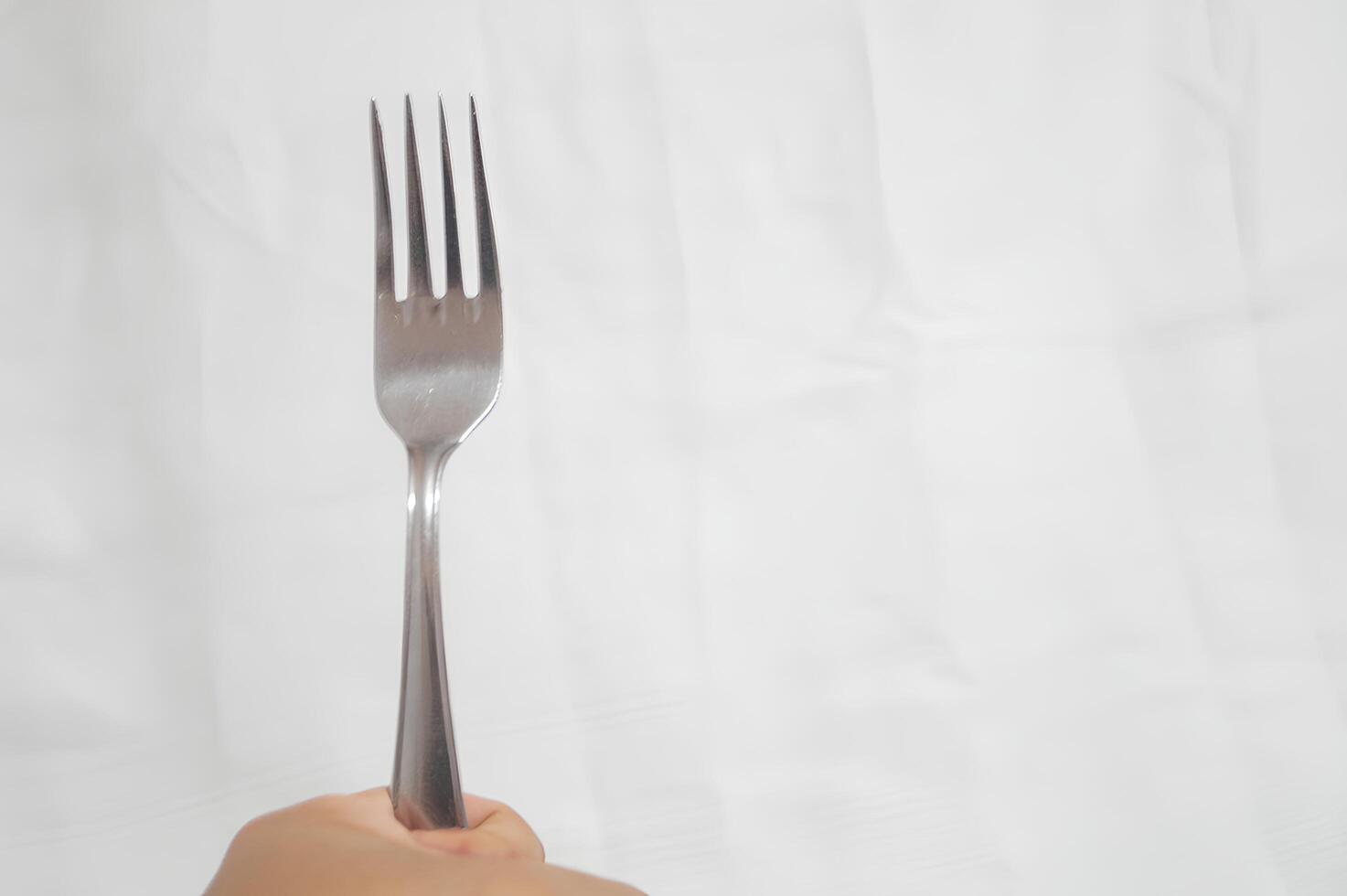 A fork is shown in a white background photo