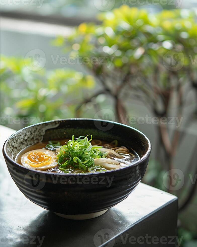 Amidst a serene setting, a bowl of bland organic ramen broth offers a gentle, soothing base for a personalized culinary journey photo