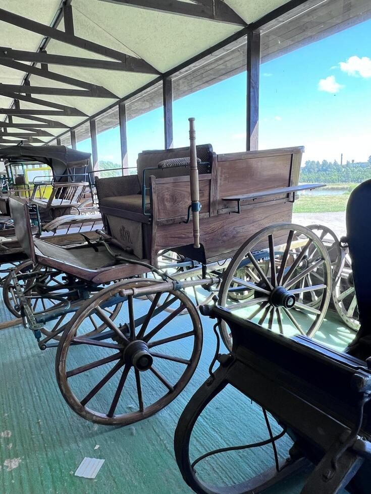 an old fashioned carriage is parked in a barn photo