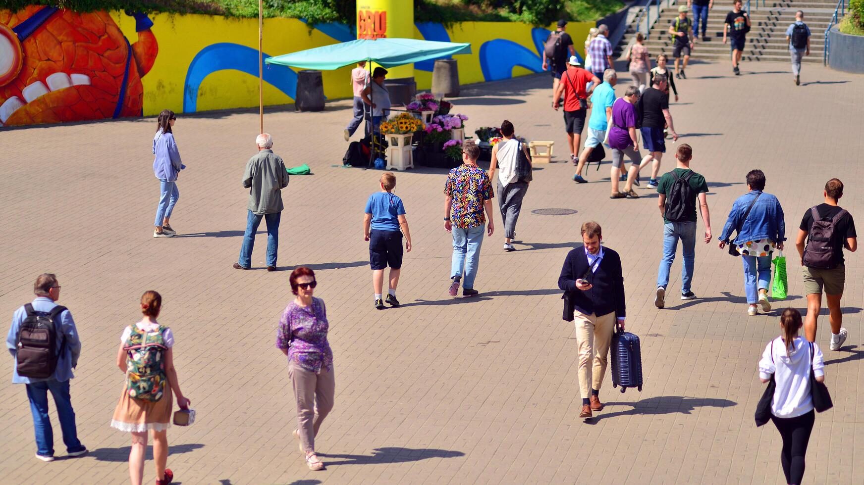 Warsaw, Poland. 8 June 2024. Crowd of people on Patelnia square in centrum city. The colloquial name. An important communication point on the city map with residents, tourists and buildings. photo